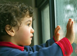 Child Looking Outside In the Rain